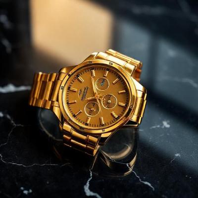 Luxury gold watch on dark marble